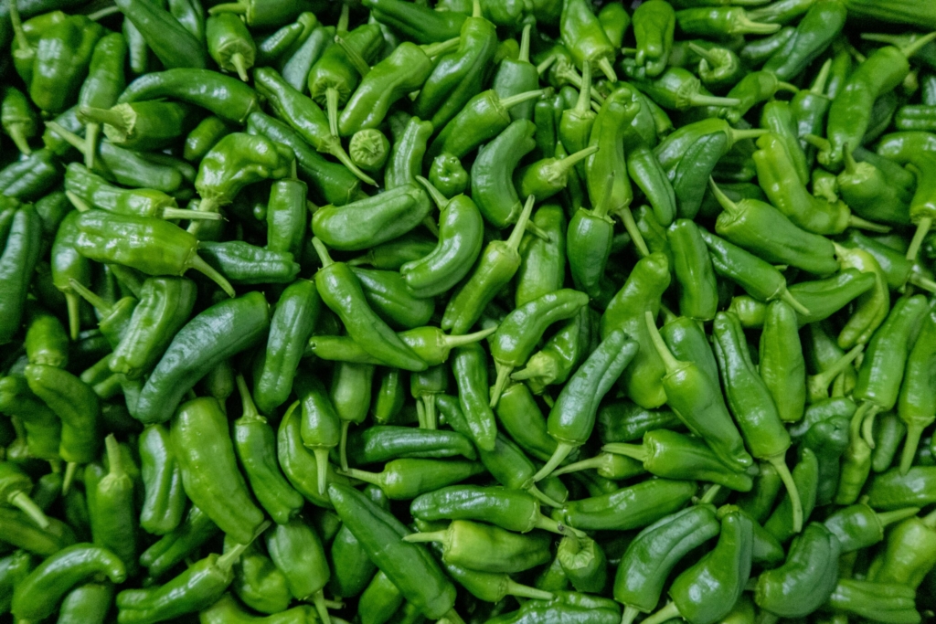 green chili peppers on green leaves